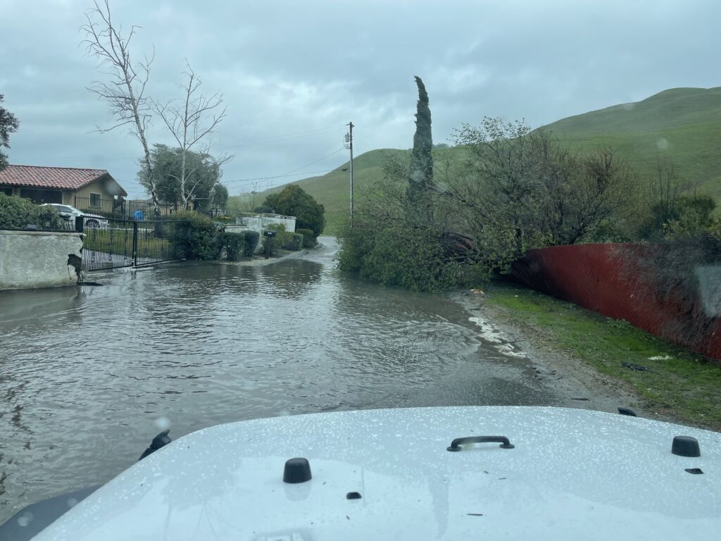 tree blocking road on Higuera Highland and flooding due to blocked drains higher up the road